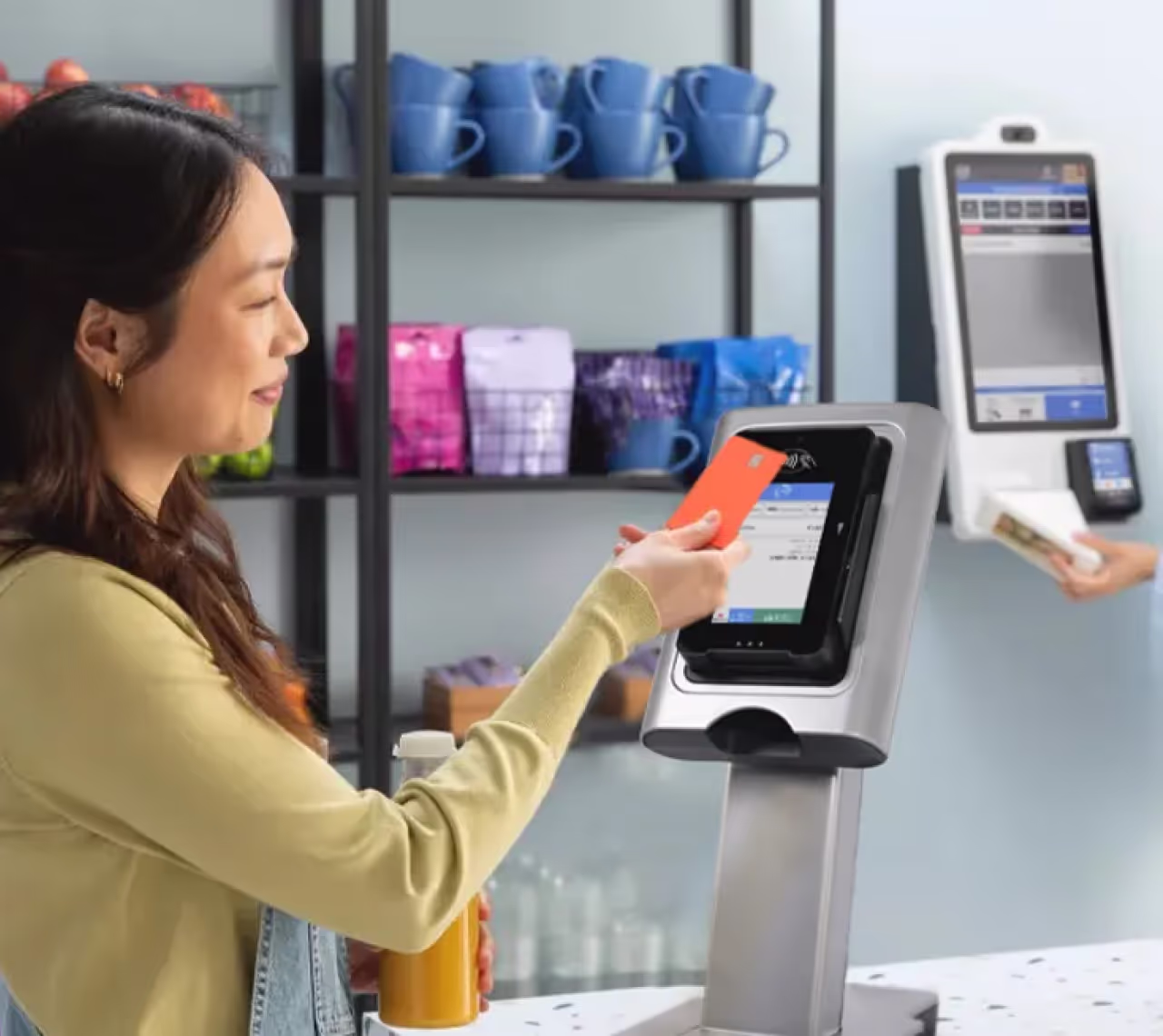 A customer tapping a phone to pay at a smart vending machine